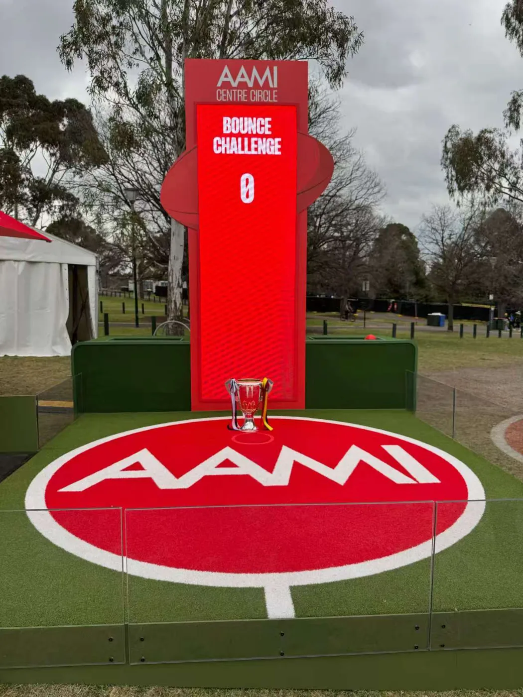 Outdoor LED totem running a fan bounce challenge on a sports field